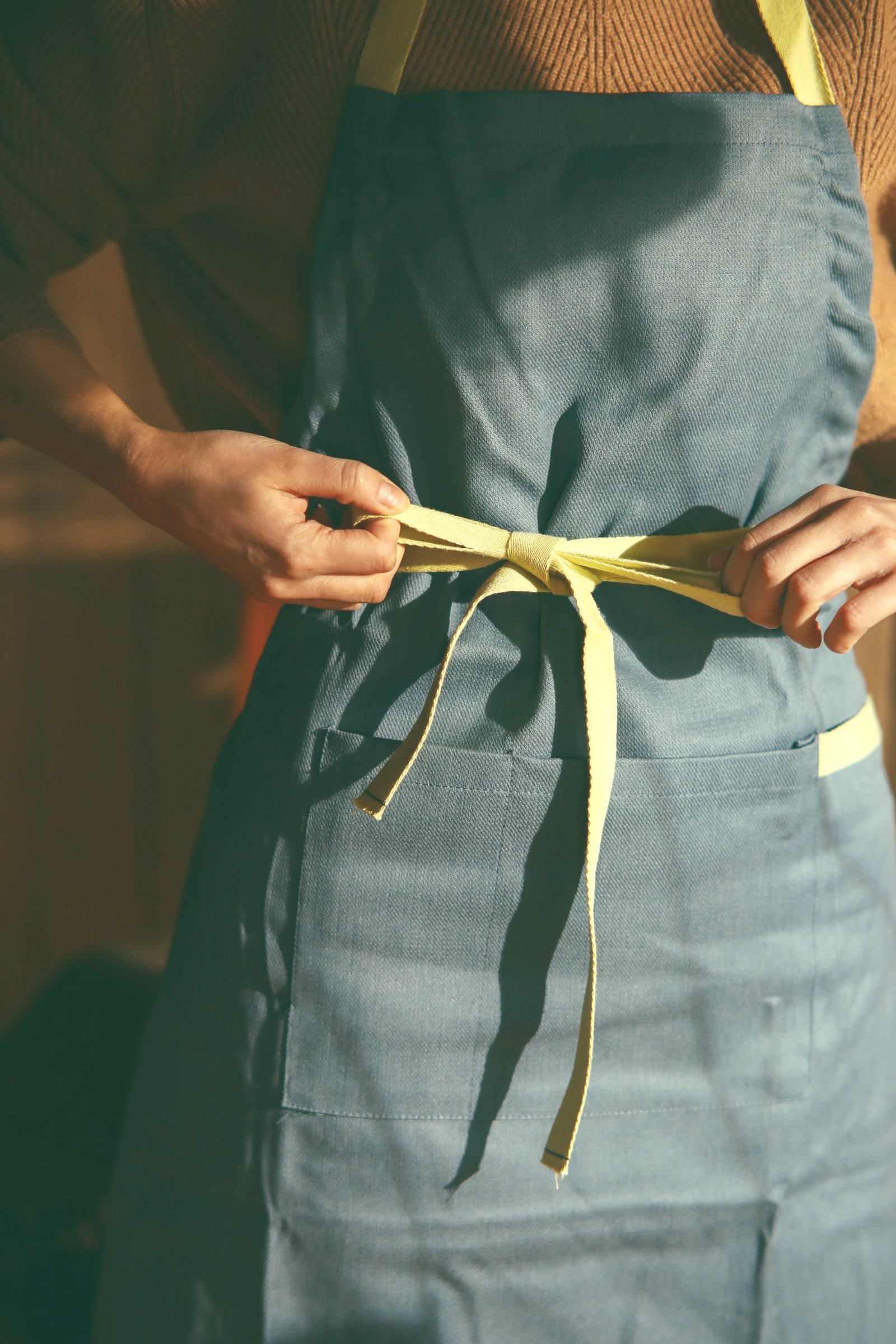 Tying on an apron before class